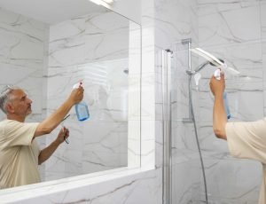 side-view-man-cleaning-shower-min